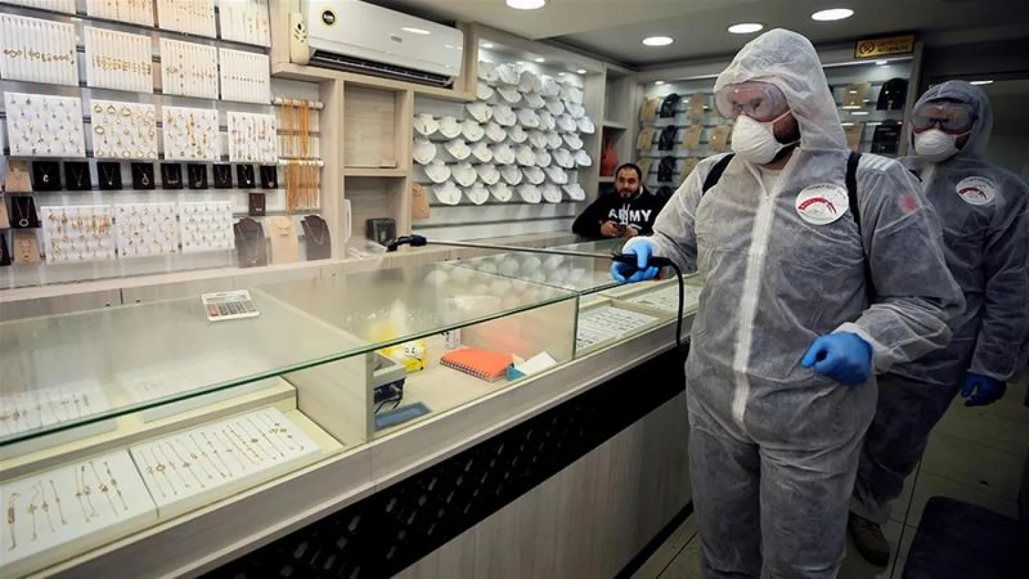 Volunteers sanitize a jewelry shop as a precaution against the spread of coronavirus in Sidon, Lebanon. Ali Hashisho/Reuters