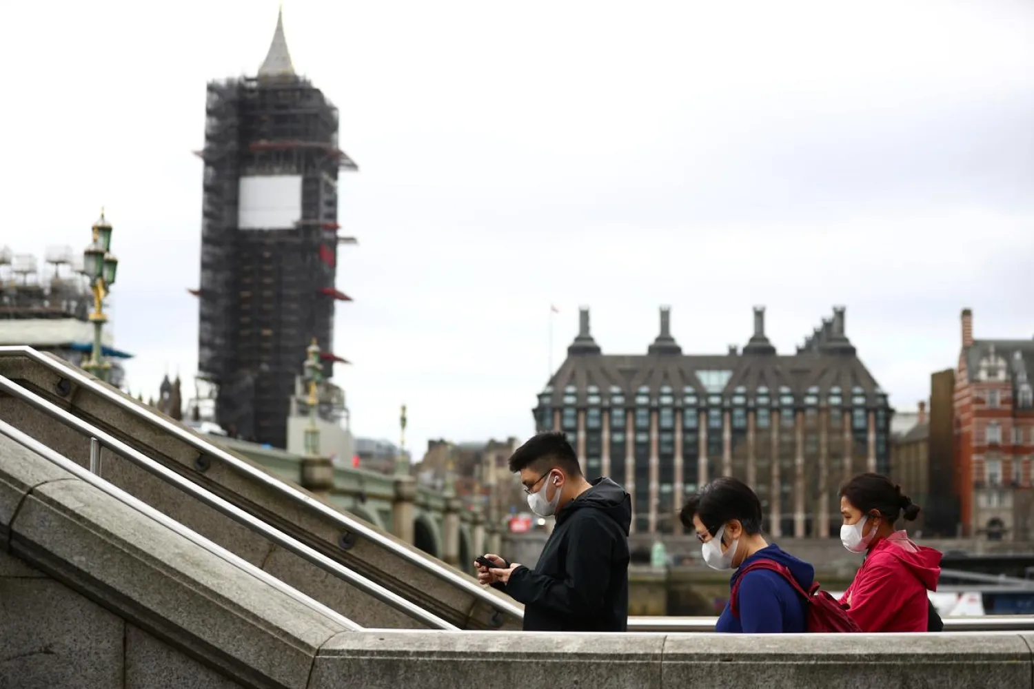 People wearing protective face masks in Westminster as the number of coronavirus cases grow around the world. London, Britain, March 17, 2020. REUTERS/Hannah McKay