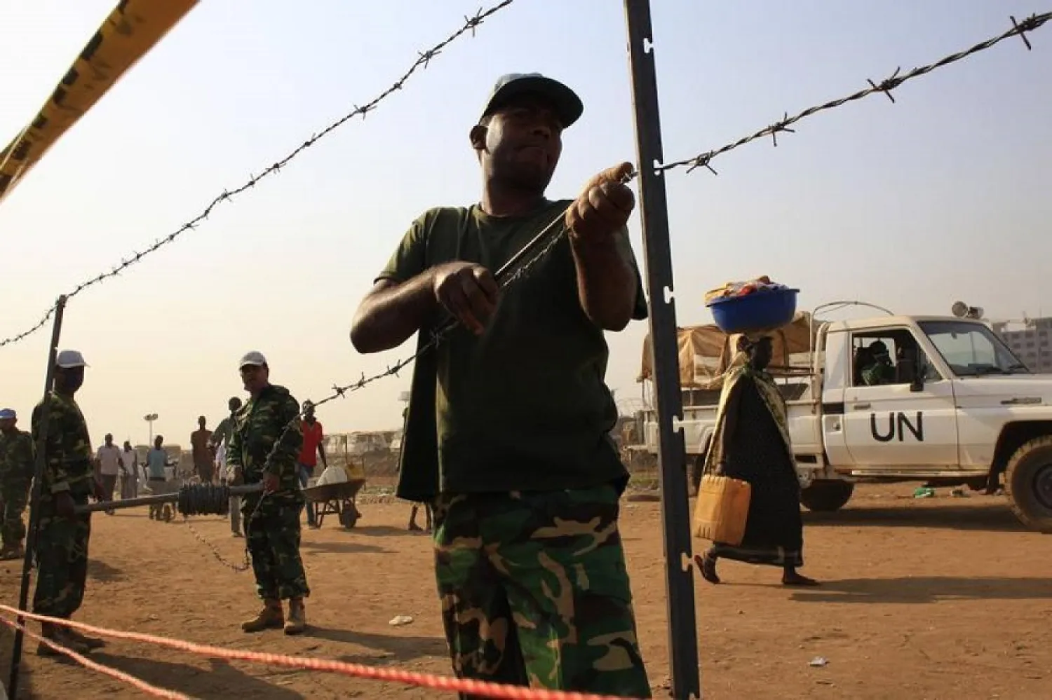 United Nations Mission in South Sudan (UNMISS) personnel erect barbed wire fencing around Tomping camp in Juba January 7, 2014. (Reuters)