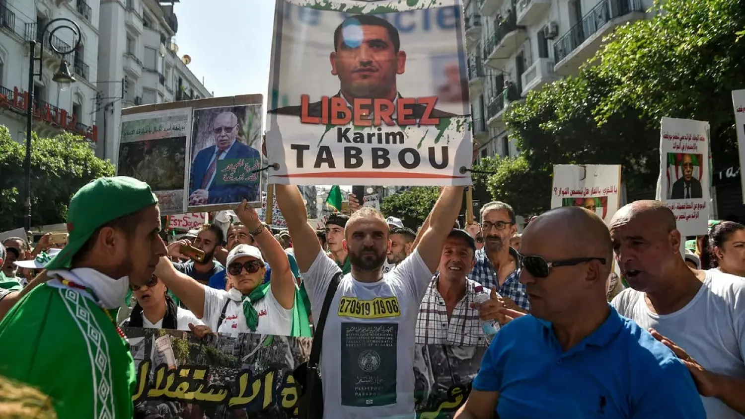 A protester carries a poster of Karim Tabbou during a rally in Algiers in September 2019. (AFP)