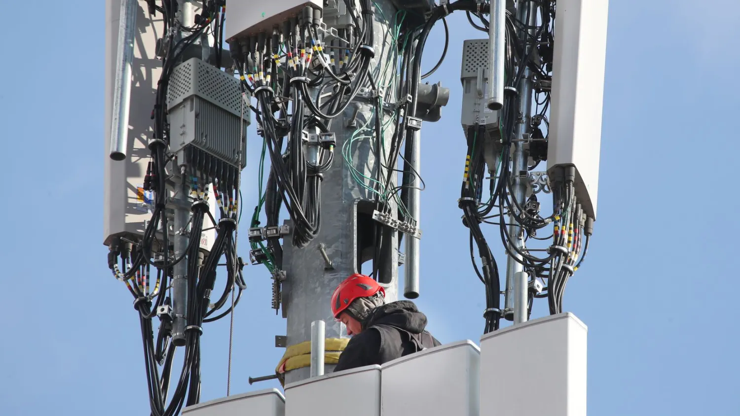 In this file photo, a worker rebuilds a cellular tower with 5G equipment for the Verizon network in Orem, Utah. (Photo by George Frey/Getty Images)(George Frey / Getty Images)