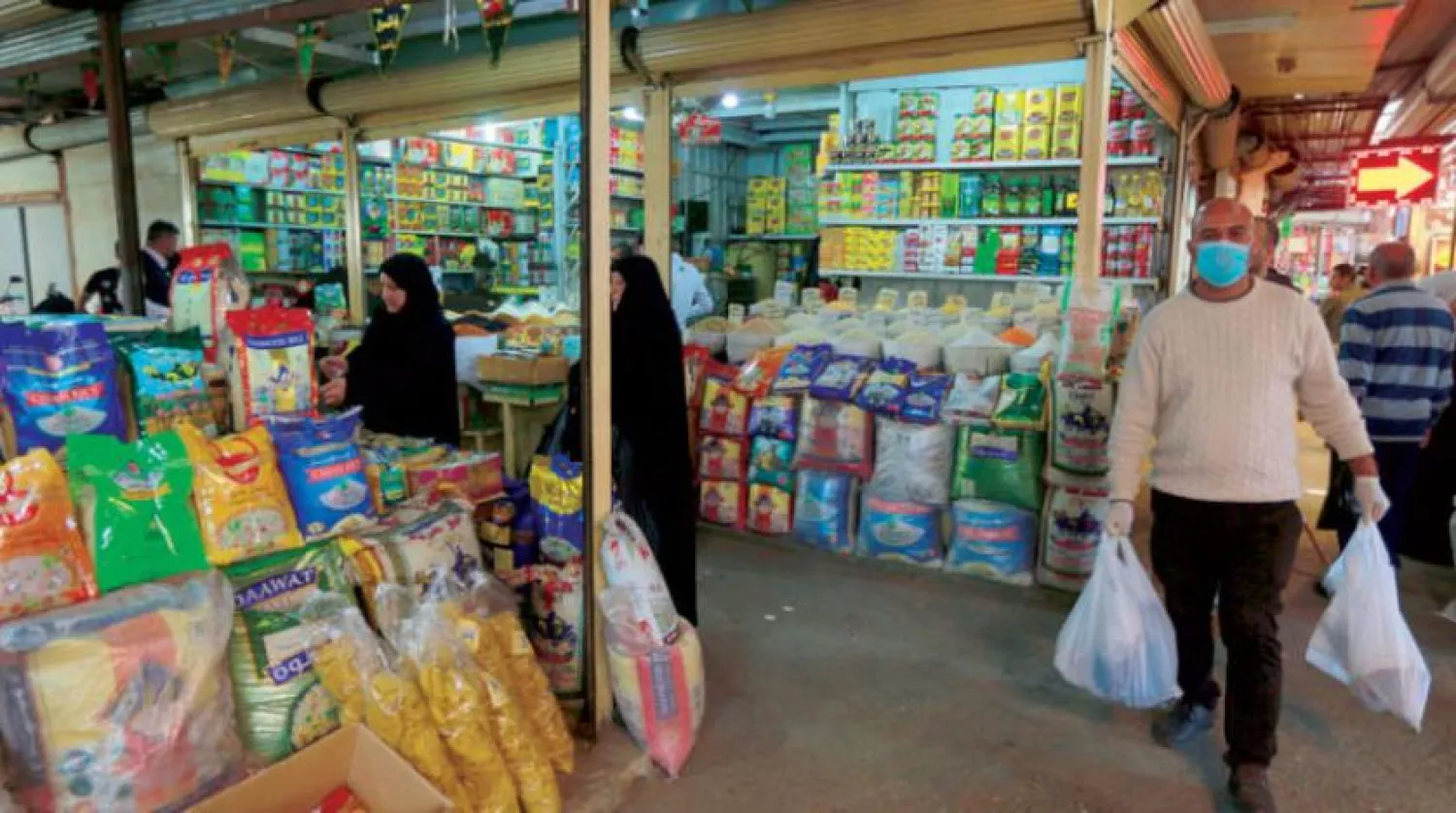 Shoppers in a Baghdad market | AP