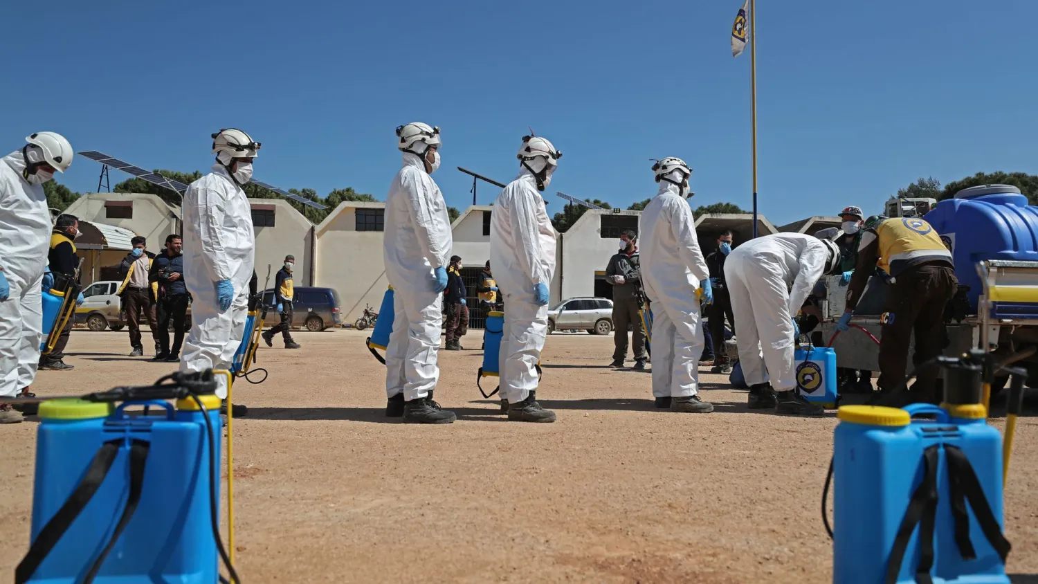 Members of the Syrian Civil Defenwe, also known as the "White Helmets", prepare their sterilization equipment before sterilizing a hospital in Syria's northwestern Idlib city on March 22, 2020 as a preventive measure against the coronavirus. (Photo by Omar HAJ KADOUR / AFP)