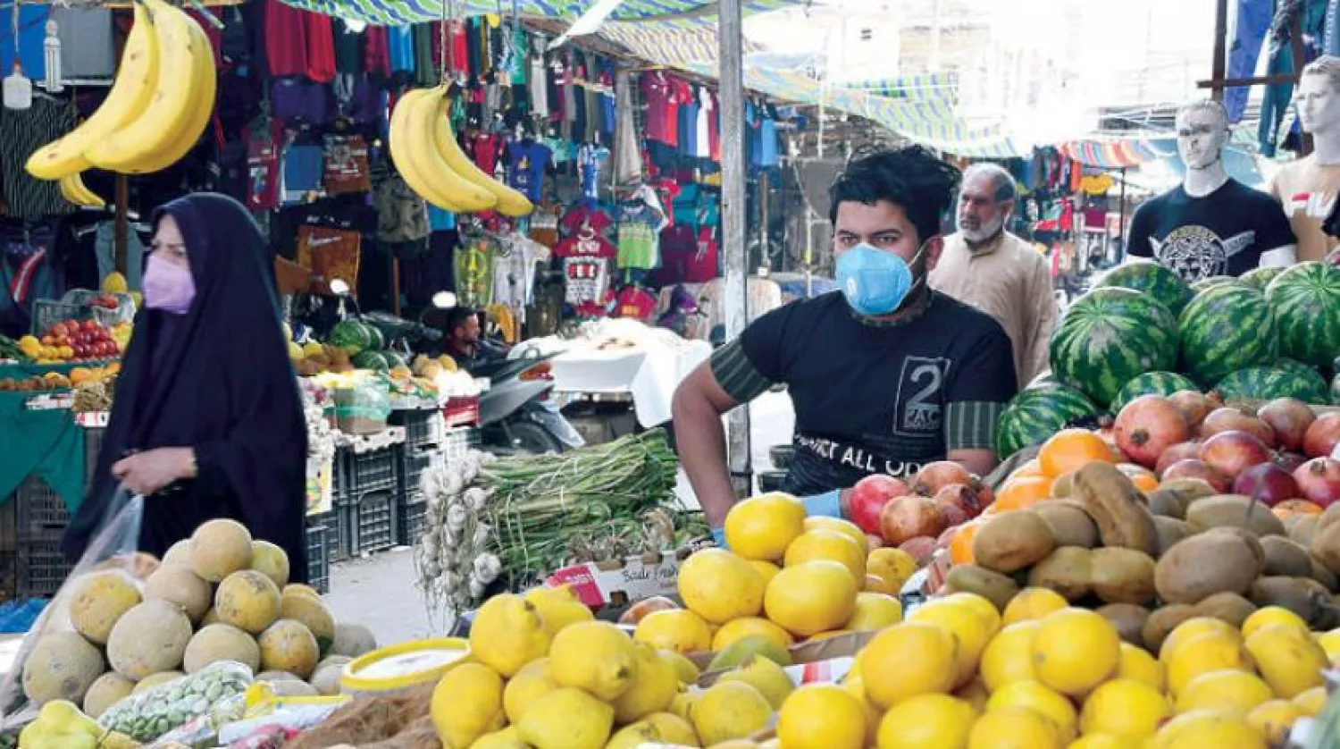 Iraqis in a market in Nassiriya on Wednesday, March 25, 2020 (AFP)
