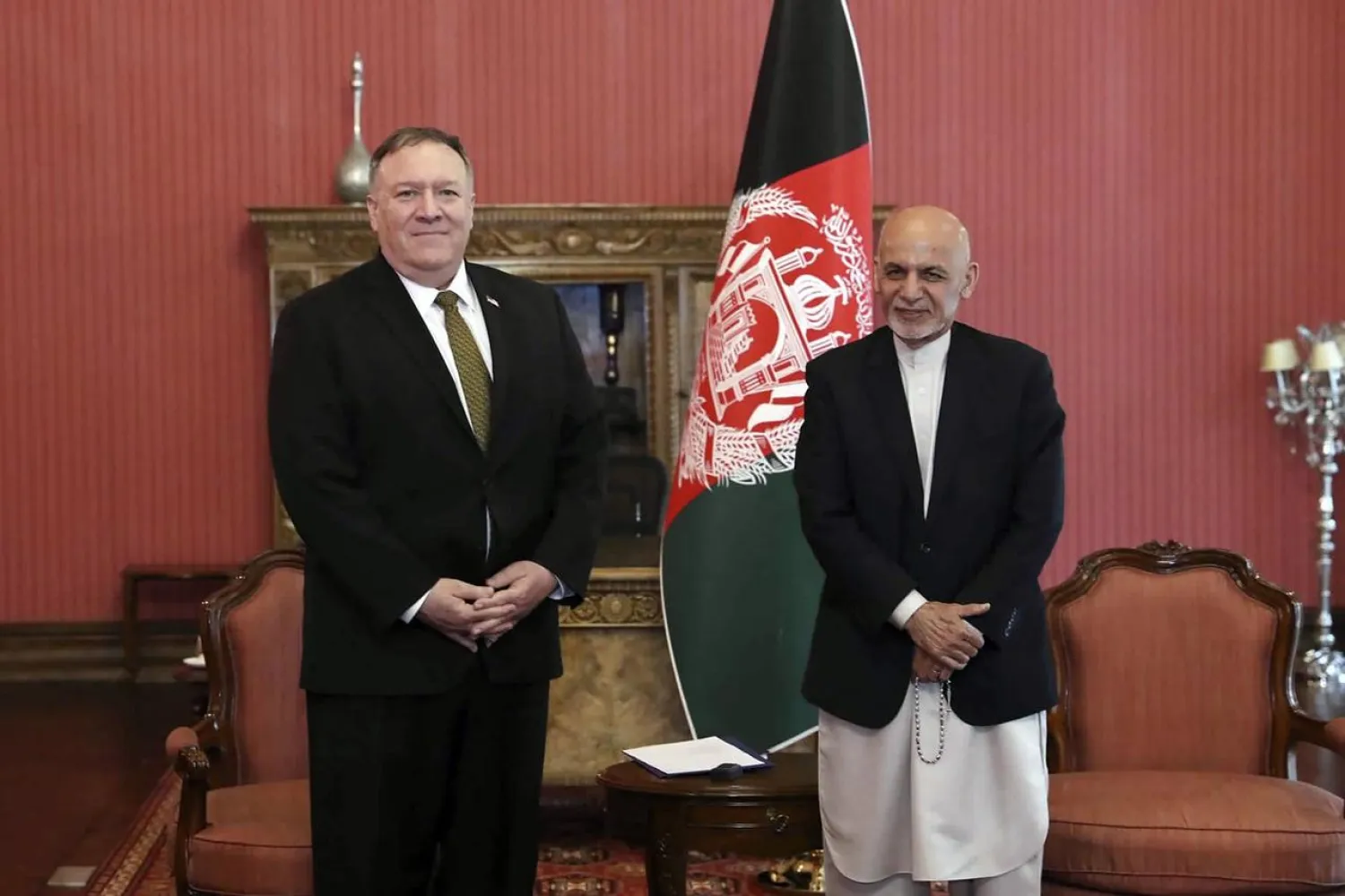 US Secretary of State Mike Pompeo, left, stands with Afghan President Ashraf Ghani, at the Presidential Palace in Kabul, Afghanistan, Monday, March 23, 2020. (Afghan Presidential Palace via AP)