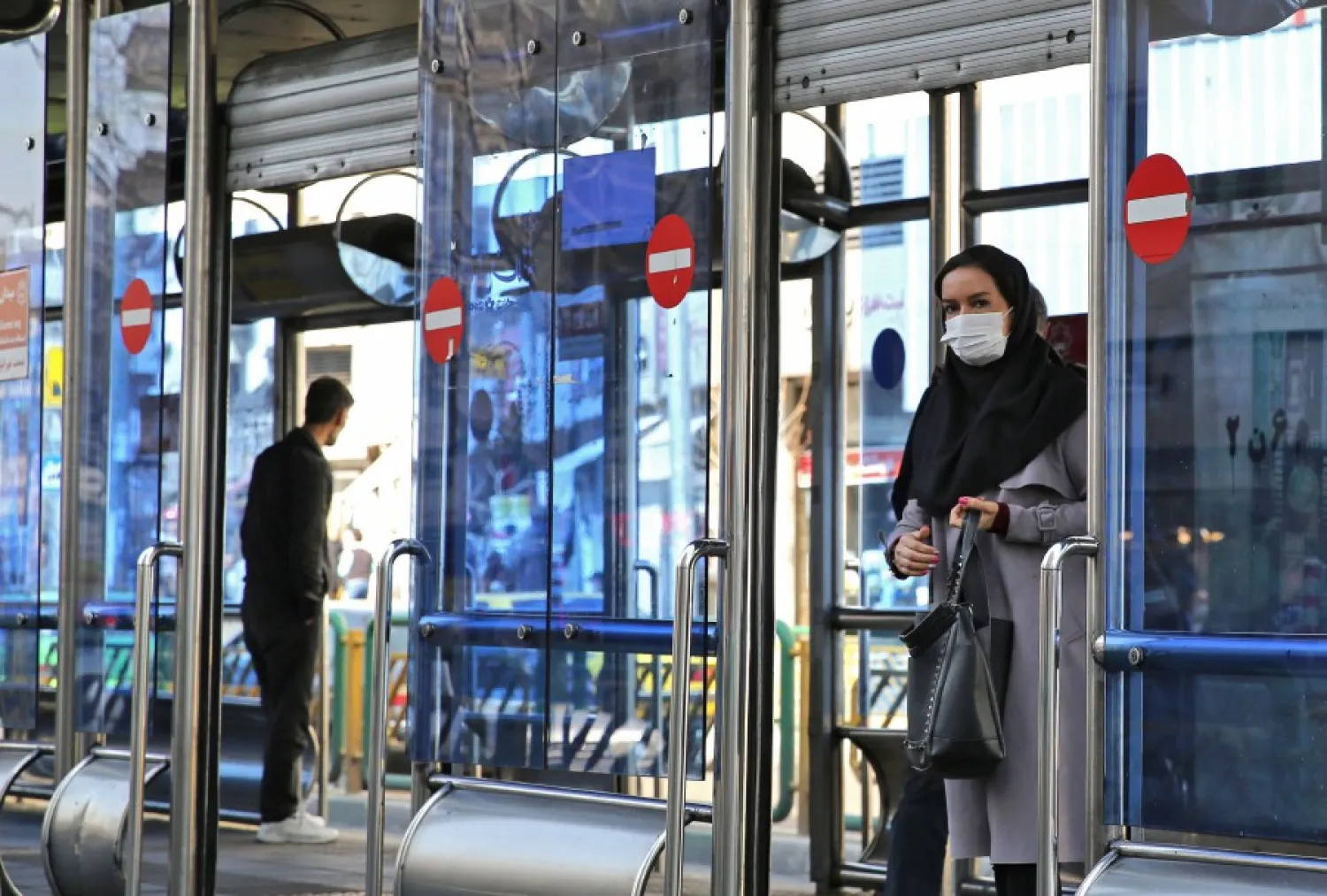 An Iranian woman wears a protective mask in the capital Tehran. - AFP 

