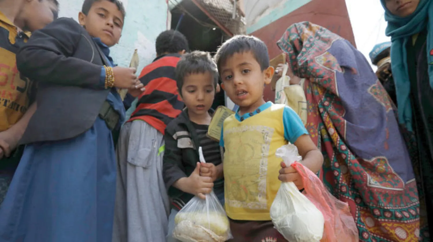 أطفال يحصلون على حصتهم من المساعدات في صنعاء (إ.ب.أ)