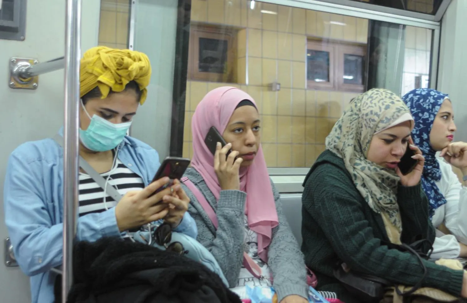 A woman wears a protective mask following an outbreak of the coronavirus disease (COVID-19) while riding a metro on a line Shubra al-Khaimah to Tahrir Square, on the outskirts of Cairo, Egypt March 10, 2020. REUTERS/Rania Goma