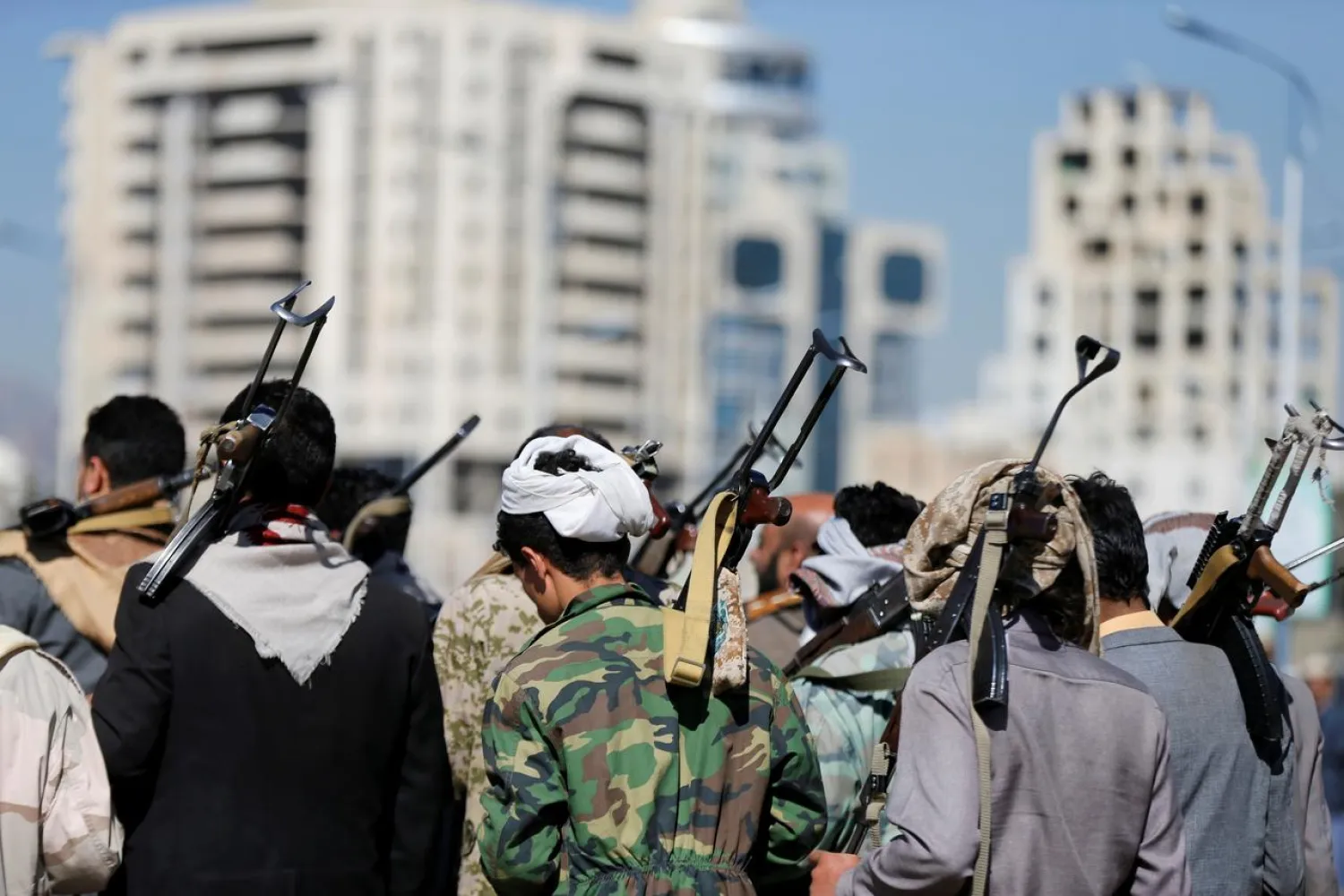 Armed Houthi followers carry their rifles as they attend a gathering to show support for the Houthi movement in Sanaa, Yemen (Reuters)