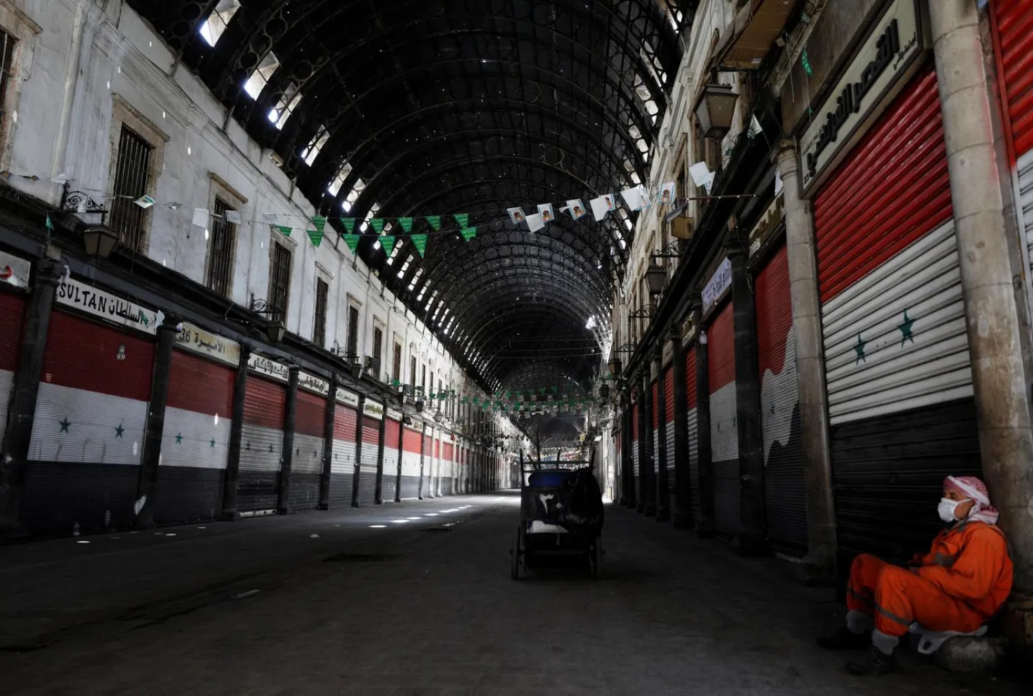 A street cleaner rests at the empty Souk al-Hamidieh in Damascus on March 24, 2020. Reuters file photo