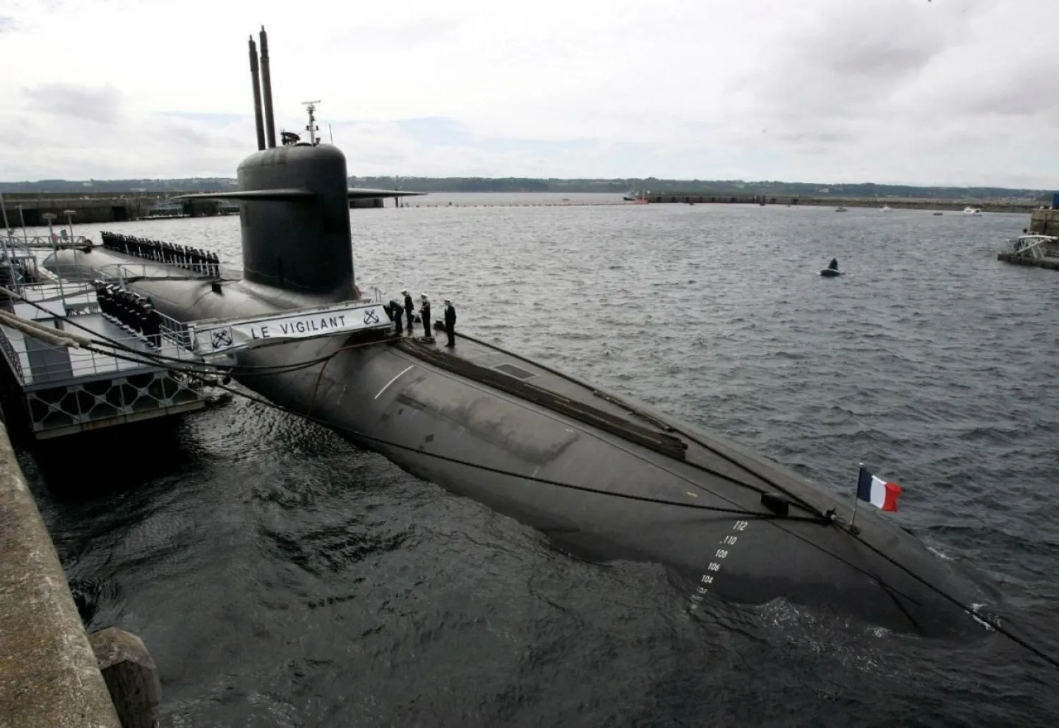 In this July 13, 2007 file photo, French Marine officers wait atop "Le Vigilant" nuclear submarine at L'Ile Longue military base, near Brest, Brittany. (AP Photo/Francois Mori, Pool, File)