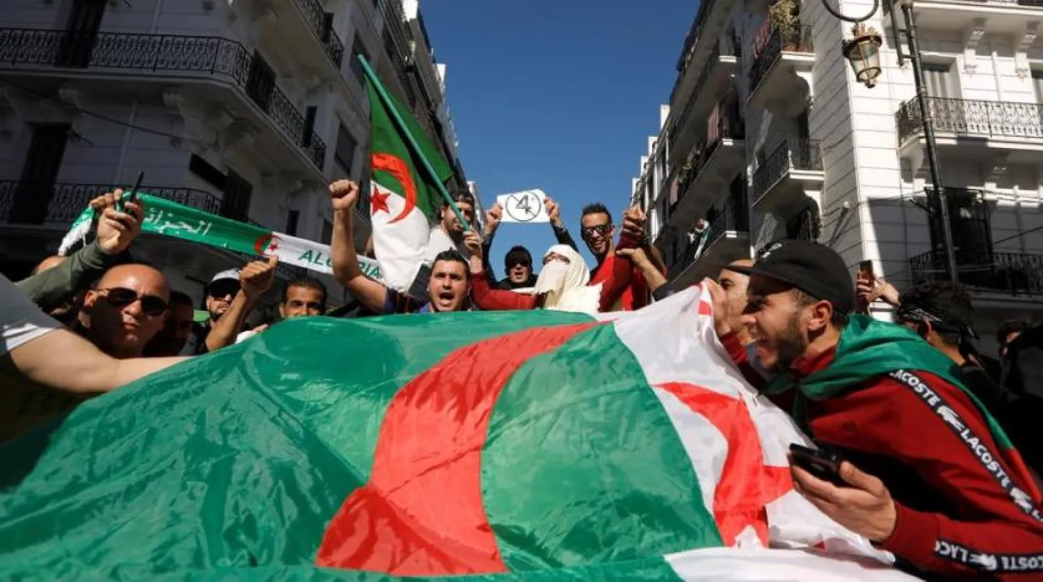 People carry the national flags during a protest in Algiers, Algeria. (Reuters file photo)