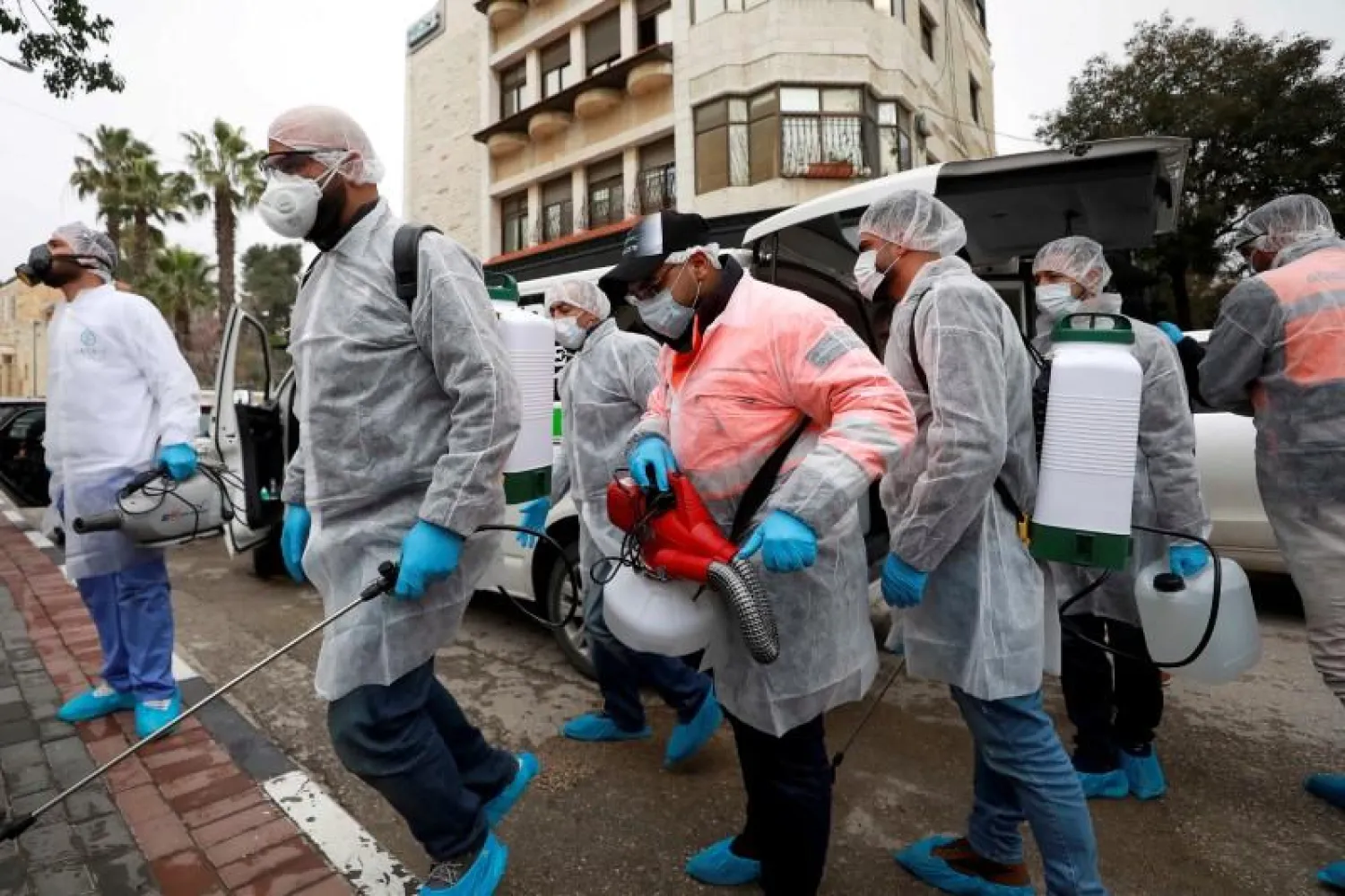 Palestinian workers make their way to disinfect religious sites as preventive measures against the coronavirus, in Ramallah (File Photo: Reuters)