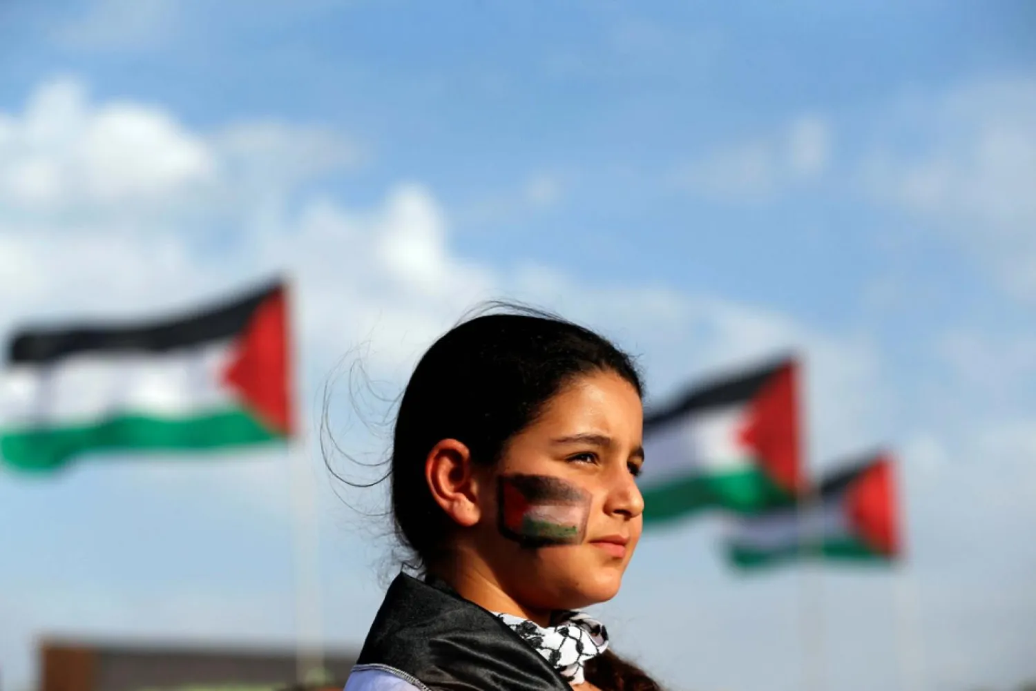  A girl takes part in a Land Day rally in Deir Hanna, Galilee region (Reuters)