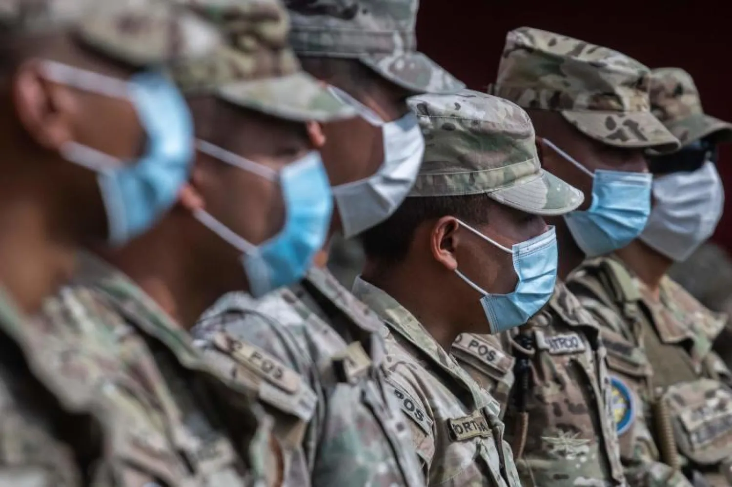 عناصر من حرس الحدود في بنما يرتدون أقنعة واقية خلال دعم متطوعين يوصلون الطعام للأسر محدودة الدخل (أ.ف.ب)