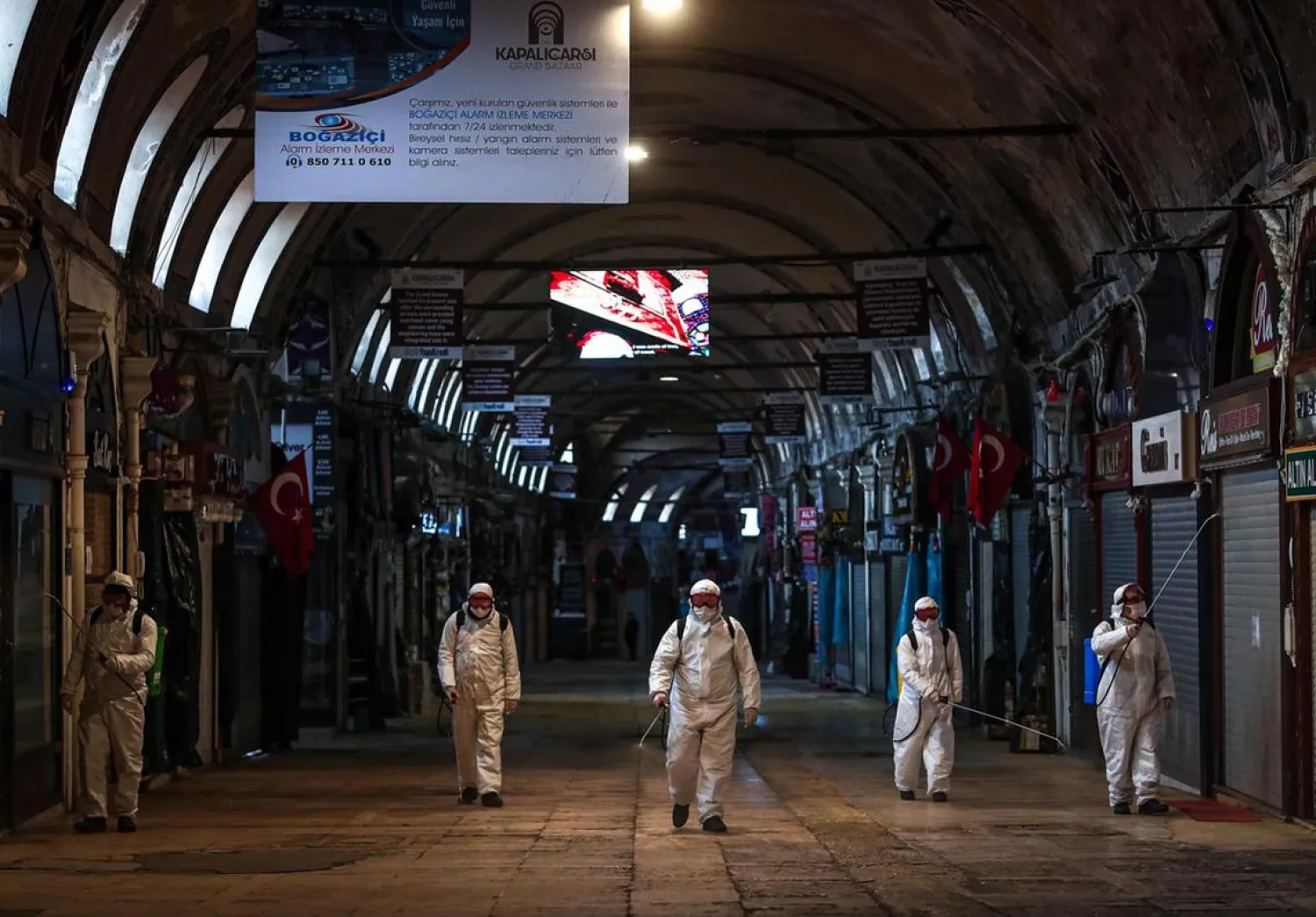 Employees disinfect streets and shops inside Istanbul's famous Grand Bazaar to prevent the spread of coronavirus. (EPA)