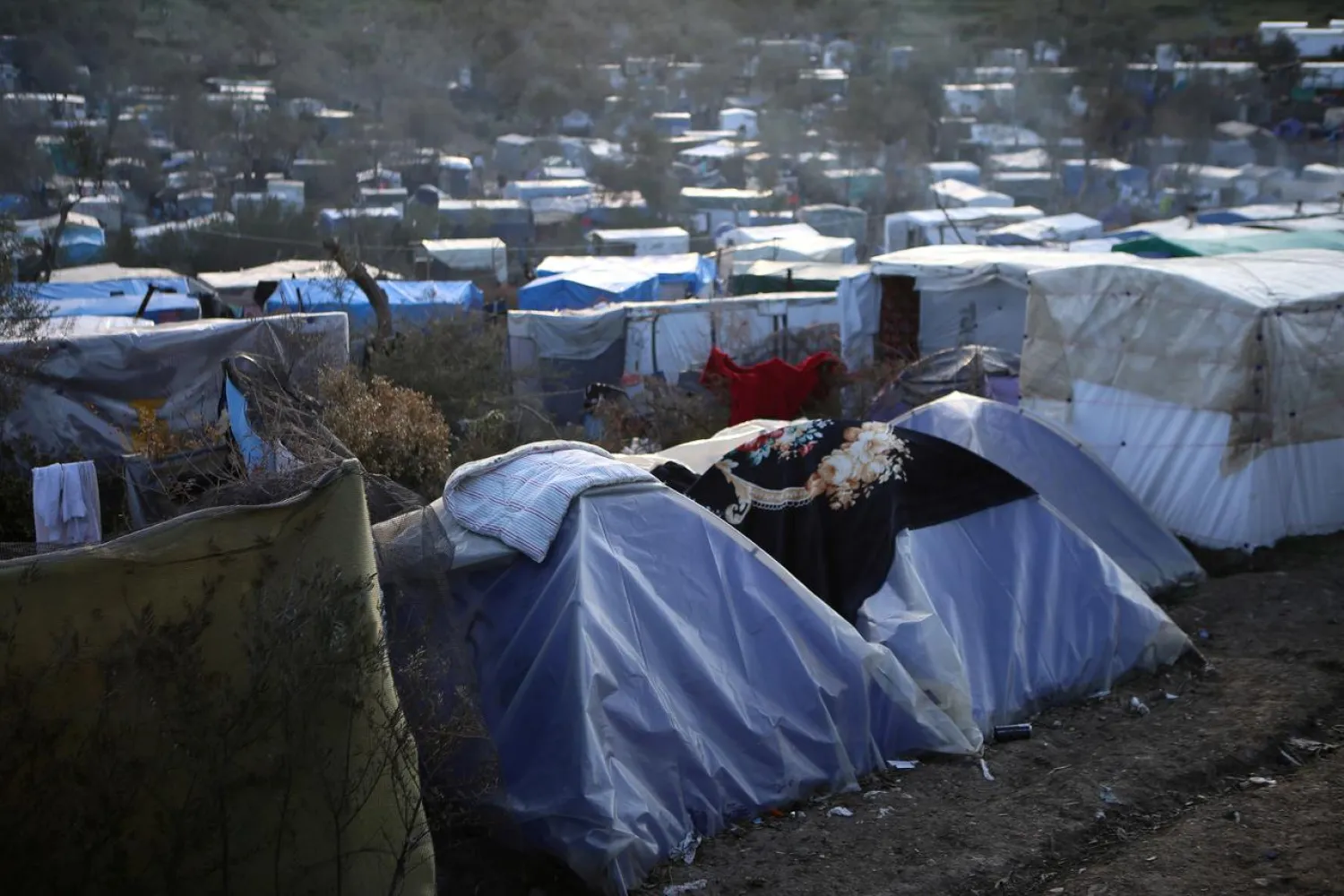 FILE PHOTO: A view of a makeshift camp for refugees and migrants next to the Moria camp, on the island of Lesbos, Greece, March 11, 2020. REUTERS/Elias Marcou/File Photo
