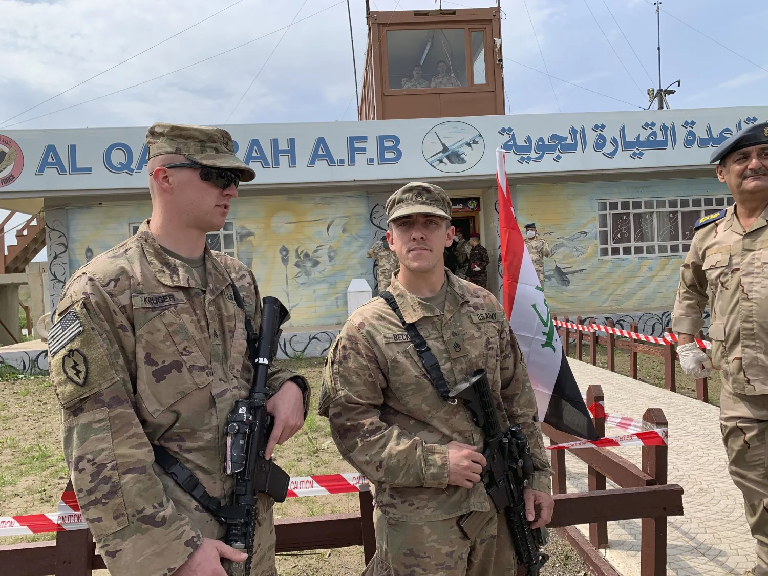 US soldiers stand guard during the hand over ceremony of Qayyarah Airfield to Iraqi Security Forces, in the south of Mosul, Iraq early Friday, March 27, 2020. (AP Photo/Ali Abdul Hassan)