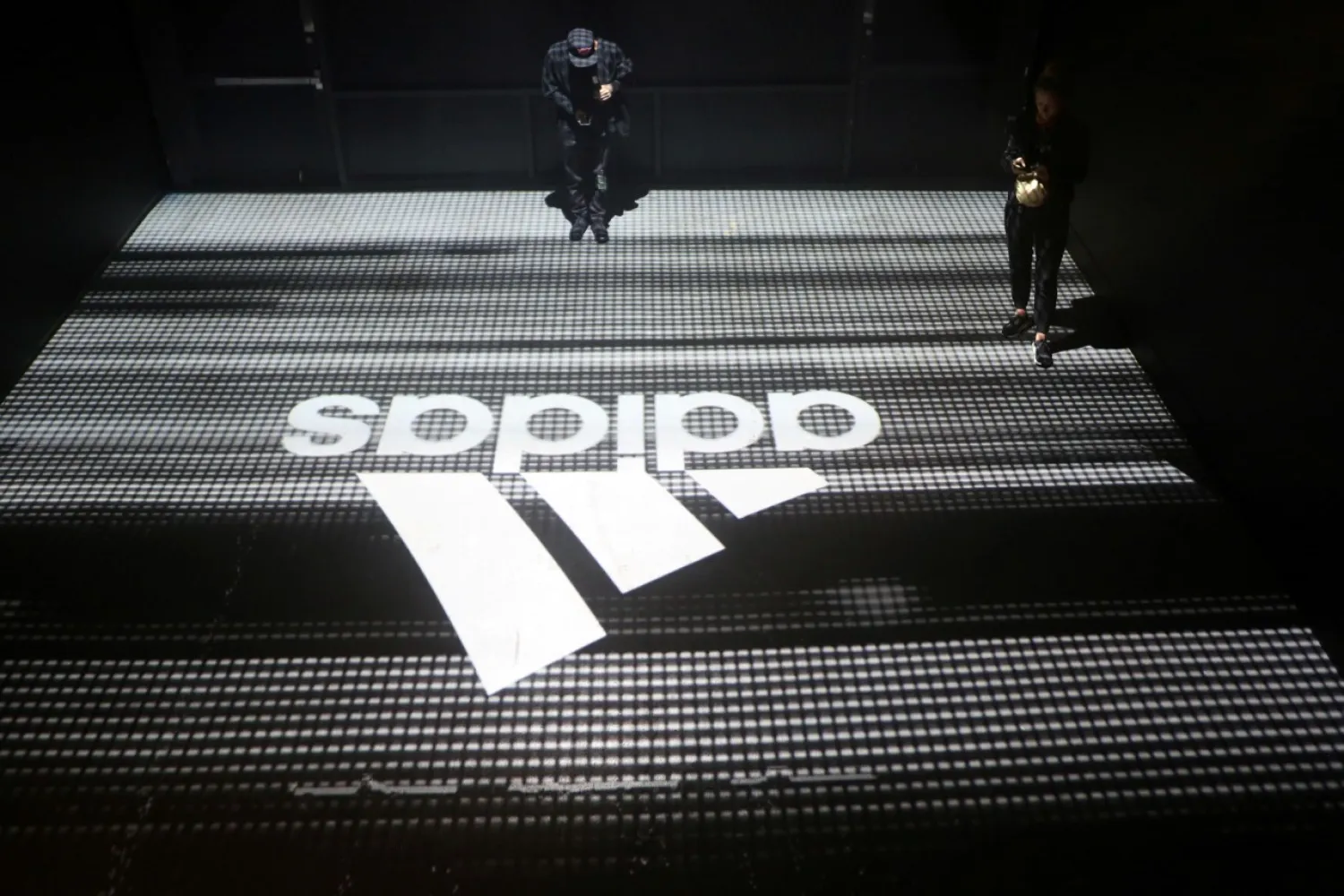 FILE PHOTO: An Adidas logo is seen at the new Futurecraft shoe unveiling event in New York City, New York, US April 6, 2017. REUTERS/Joe Penney/File Photo