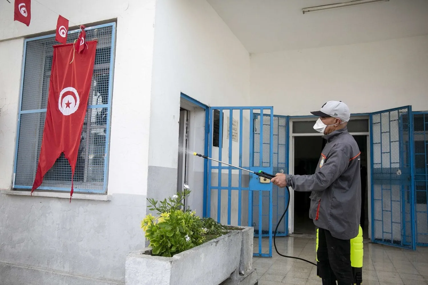 A Tunisian public health worker disinfects an office in Tunis, Tunisia, Friday, March, 13. (AP)