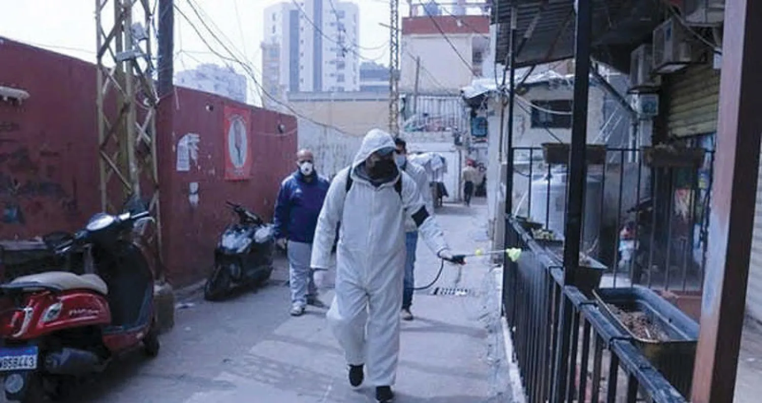 تعقيم أحد المخيمات الفلسطينية في لبنان أمس (أونروا - تويتر)