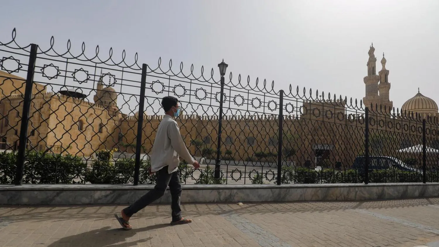 A man walks past the closed al-Azhar Mosque in Cairo which has been closed along with other places of worship to stop the spread of coronavirus in Egypt. (Reuters)