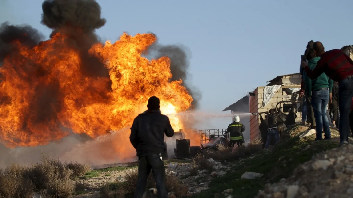 Civil Defense members put out a fire that spread in an oil refinery in the town of Maarat al-Numan in Idlib province, Syria March 10, 2016. (Reuters)