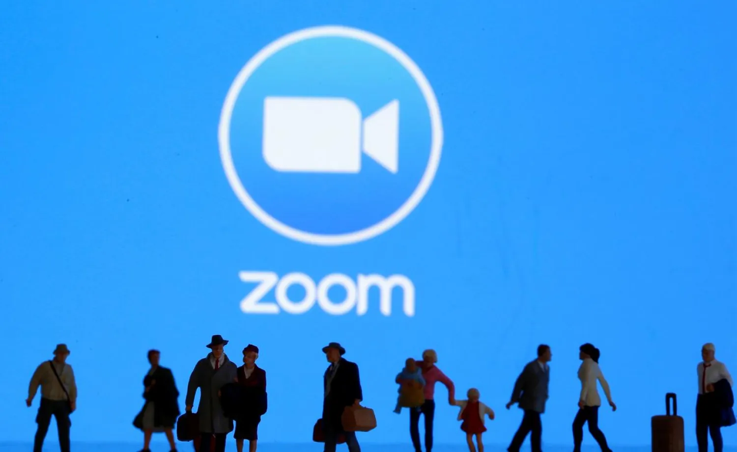 FILE PHOTO: Small toy figures are seen in front of displayed Zoom logo in this illustration taken March 19, 2020. REUTERS/Dado Ruvic/Illustration