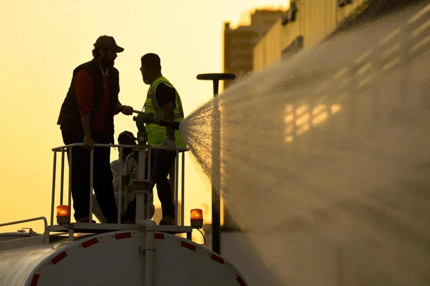 Municipality workers spray disinfectant as a precaution against the spread of coronavirus at the Kuwait Salmiya market. (EPA)
