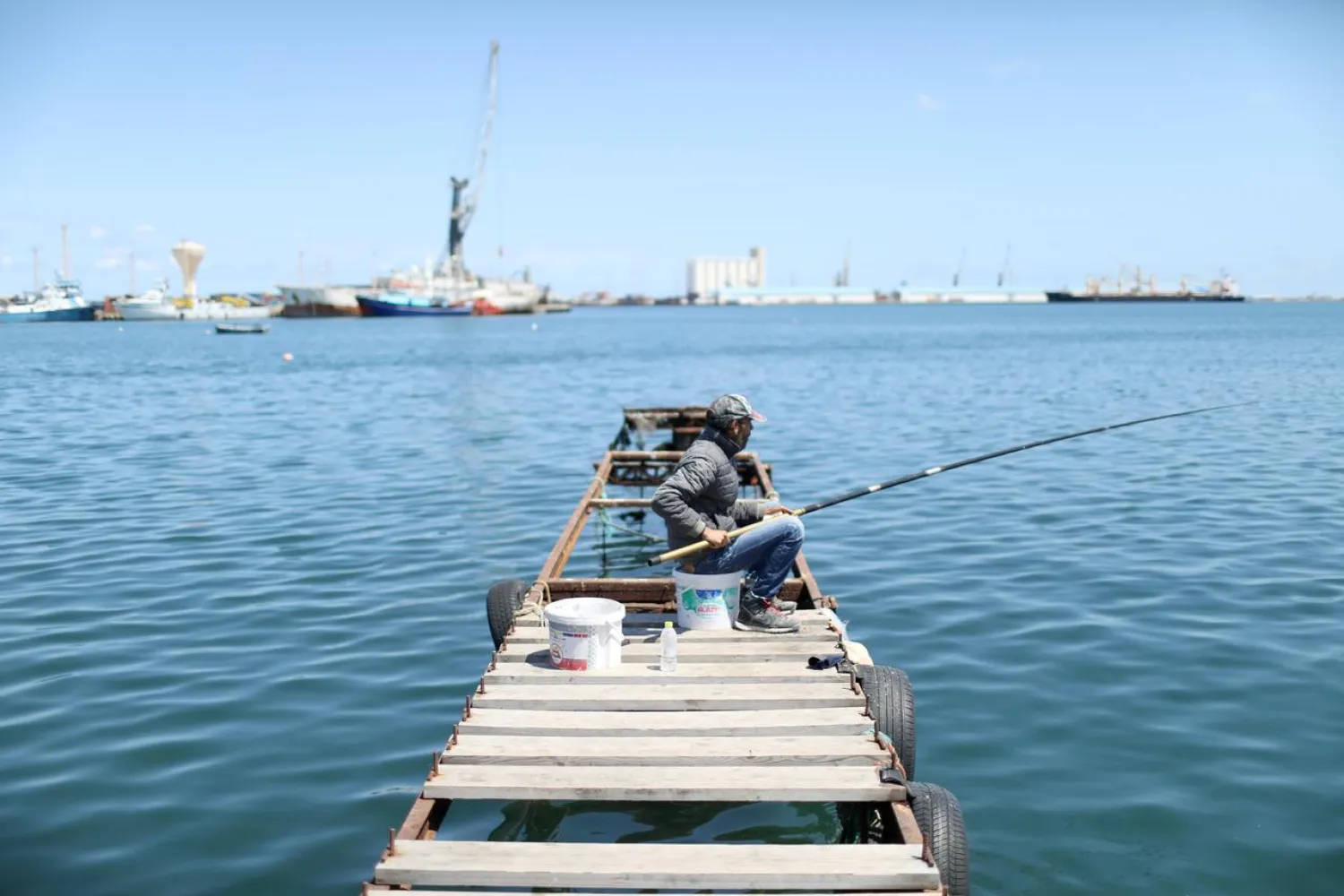 A Libyan man fish at the coast of the Mediterranean Sea in Tripoli, Libya April 12, 2019. REUTERS/Ahmed Jadallah