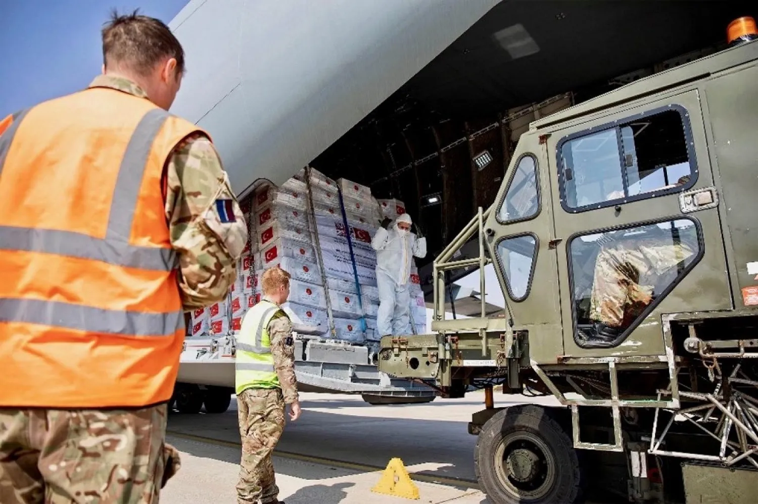 British and Turkish air force personnel unload personal protection equipment from Turkish aircraft after it arrived at RAF Brize Norton on Friday. (AFP)