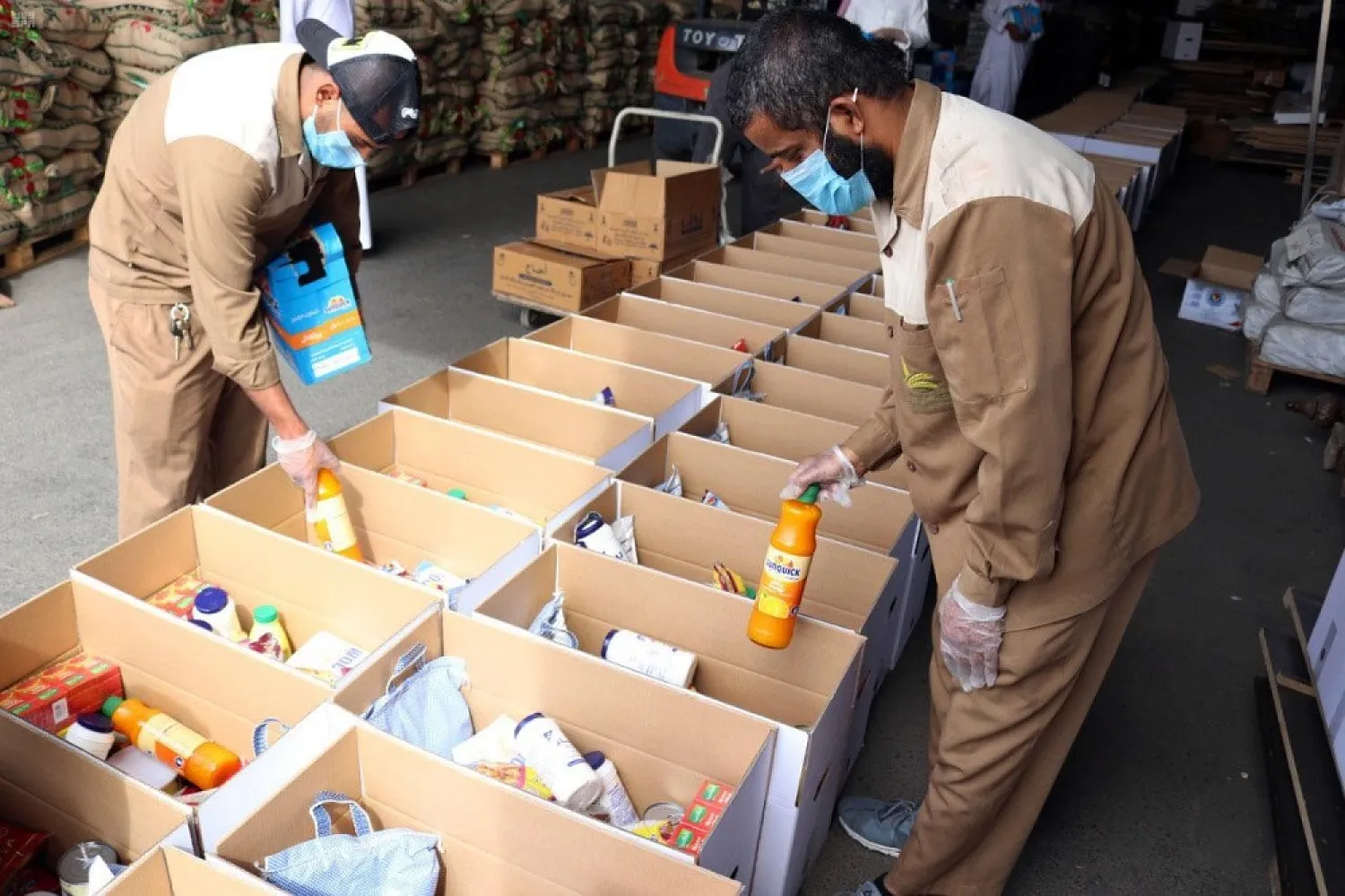 Charities prepare food baskets to those in need in Madinah, Saudi Arabia. (SPA)