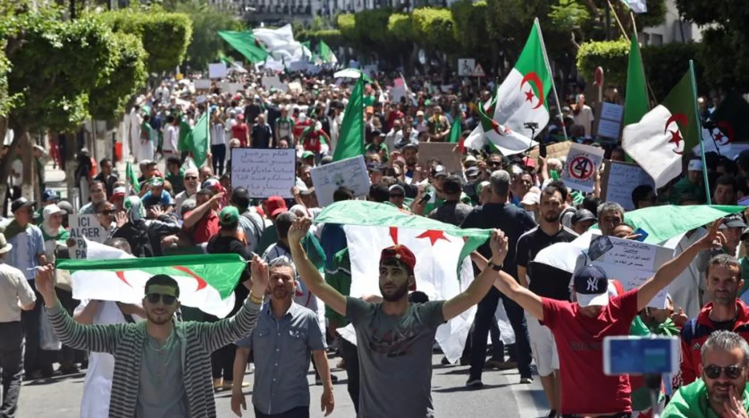 Algerian protesters march with national flags during an anti-government demonstration in the capital Algiers. AFP file photo