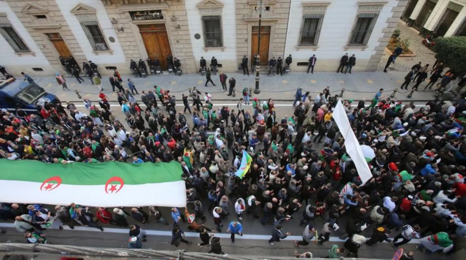 Protesters hold flags during an anti-government demonstration in Algiers (file photo: Reuters)
