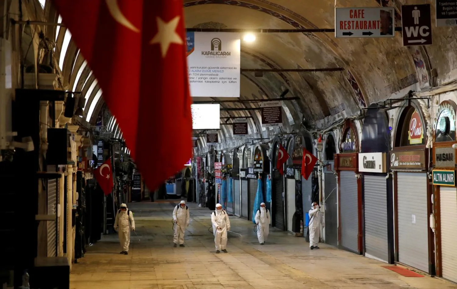 FILE PHOTO: Workers in protective suits spray disinfectant at Grand Bazaar, known as the Covered Bazaar, to prevent the spread of coronavirus disease (COVID-19), in Istanbul, Turkey, March 25, 2020. REUTERS/Umit Bektas/File Photo