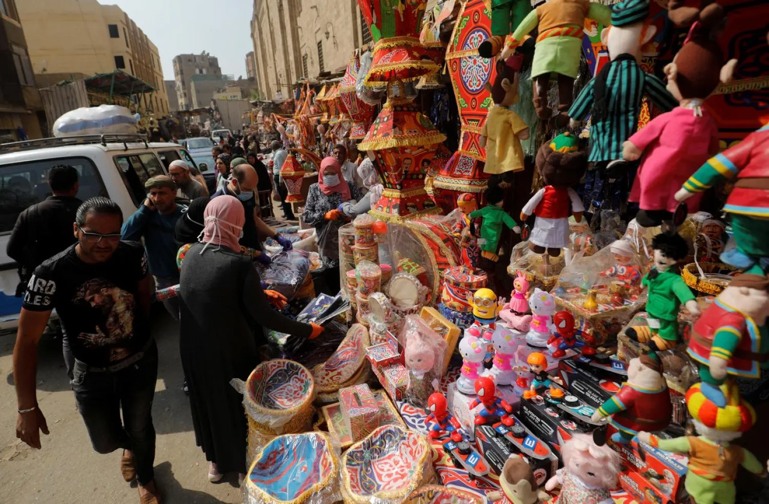 People wearing protective face masks, amid concerns over the coronavirus, shop traditional Ramadan products at Al Khayamia street in old Cairo, Egypt April 16, 2020. (Reuters)