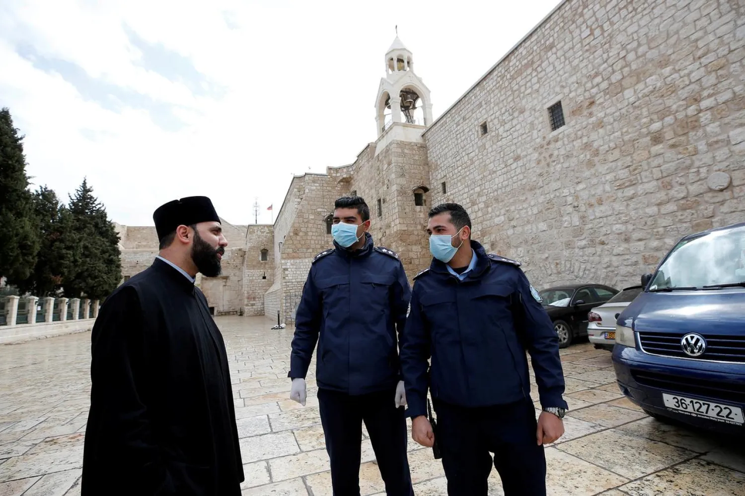 Palestinian police officers stand guard outside the Church of the Nativity that was closed as a preventive measure against the coronavirus, in Bethlehem in the Israeli-occupied West Bank March 6, 2020. REUTERS/Mussa Qawasma