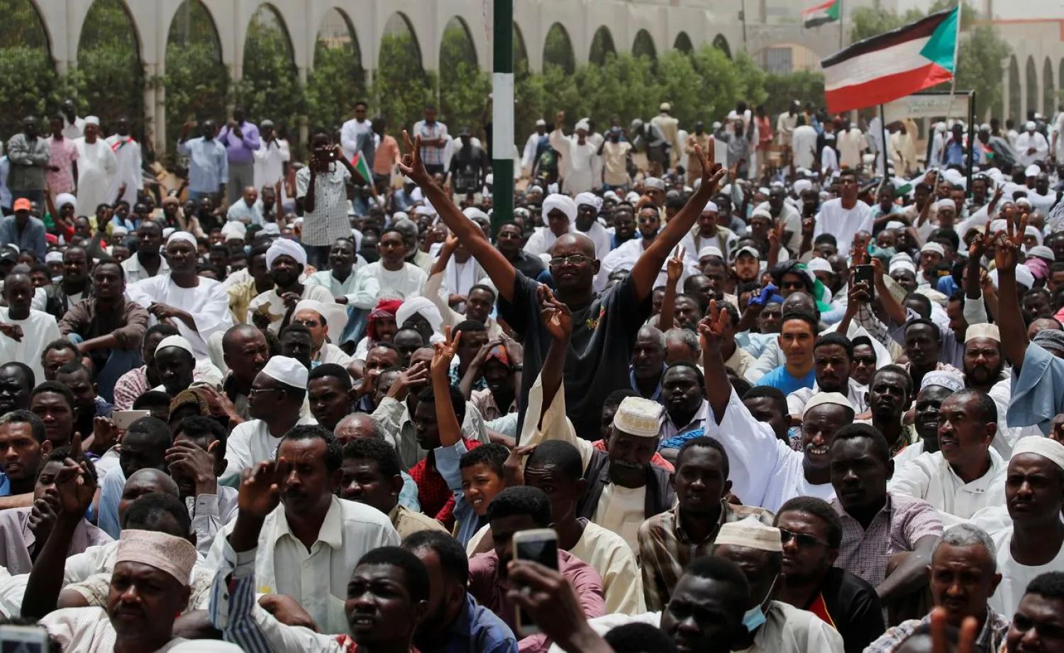 Protesters shout slogans and make victory signs after Friday prayers in front of the Defense Ministry in Khartoum, Sudan, April 19, 2019. (Reuters)