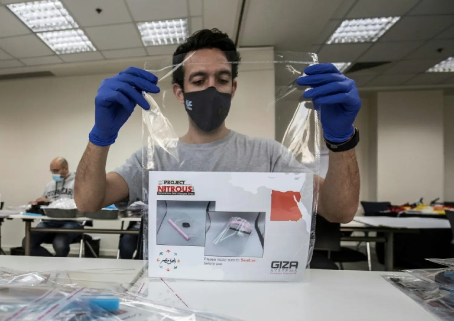 The Giza Systems Education Foundation make protective face shield for use by medical professionals treating COVID-19 coronavirus patients | AFP