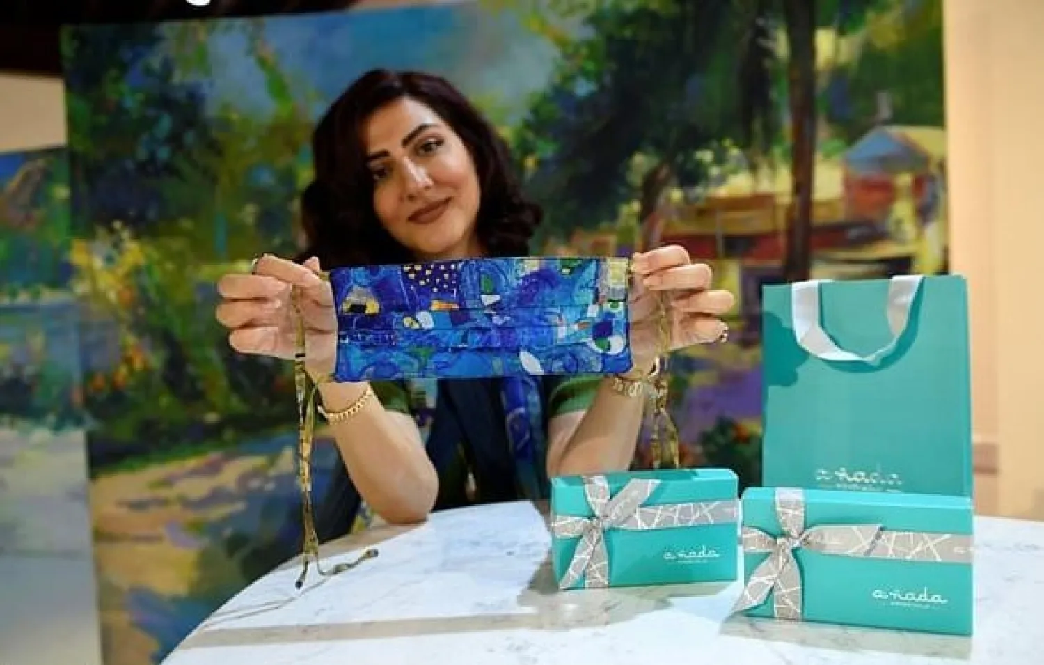 Bahraini entrepreneur Nada Alawi displays a colourful protective mask created by her company Annada. AFP