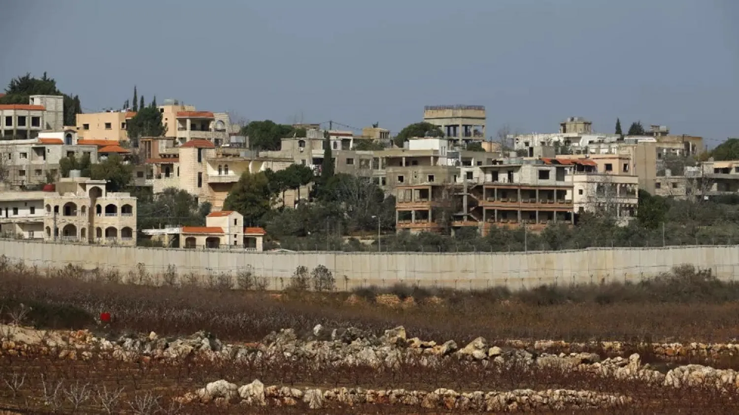 A picture taken from the Israeli town of Metula shows the Israeli-built wall dividing it from the southern Lebanese village of Kafr Kila. (AFP)