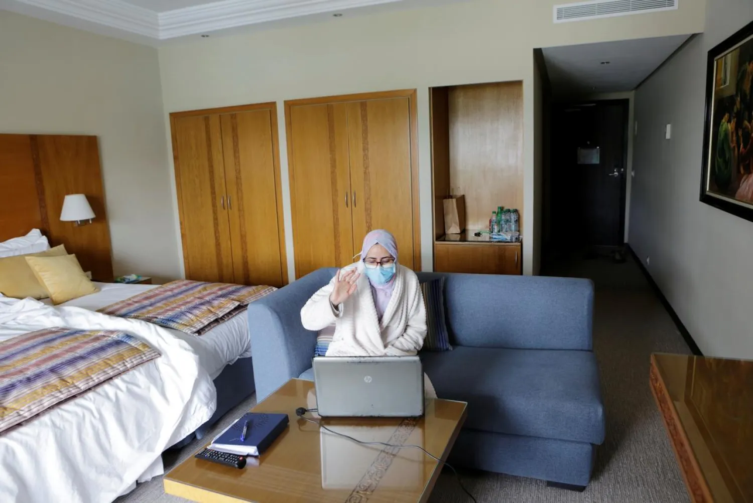 Nurse anesthetist Teimi Hakima uses a laptop to make a video call and speak with her family in her room at hotel Dawliz which is used as a temporary shelter location for all medical staff to increase social distancing during the coronavirus disease (COVID-19) outbreak in Sale, Morocco. April 24, 2020. Picture taken April 24, 2020. REUTERS/Youssef Boudlal