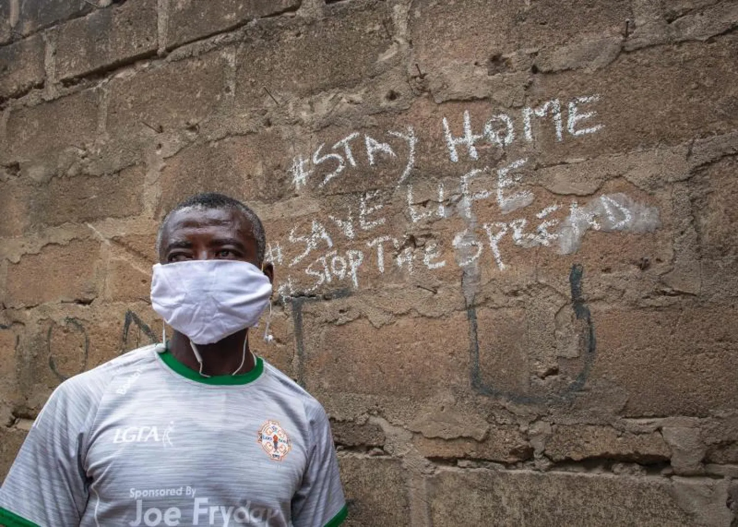 مواطن بغانا يرتدي قناعاً واقياً (أ.ف.ب)