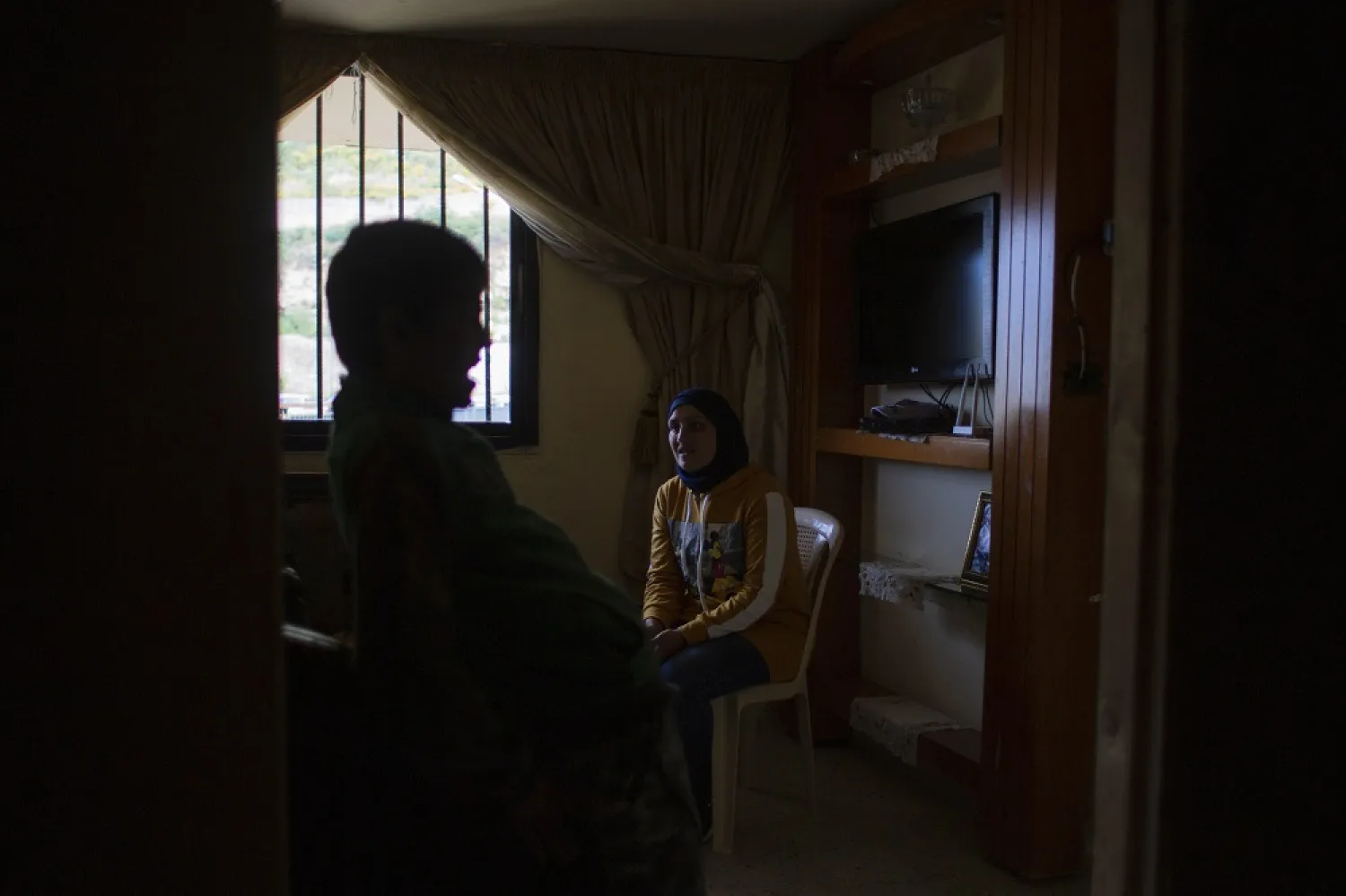 In this Tuesday, May 5, 2020 photo, Faiqqa Homsi speaks during an interview inside her apartment in the Mulawiya slum of the northern city of Tripoli, Lebanon. (AP)
