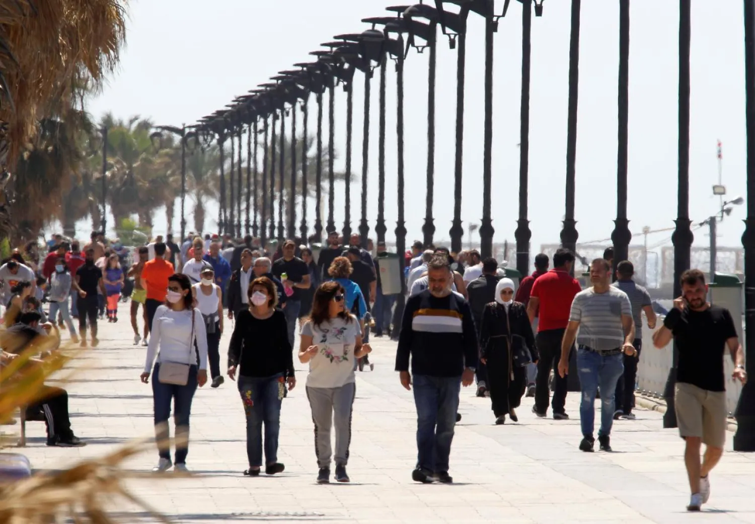 People walk along Beirut's seaside Corniche after the government eased some restrictions on public life, in Beirut, Lebanon May 10, 2020. (Reuters)