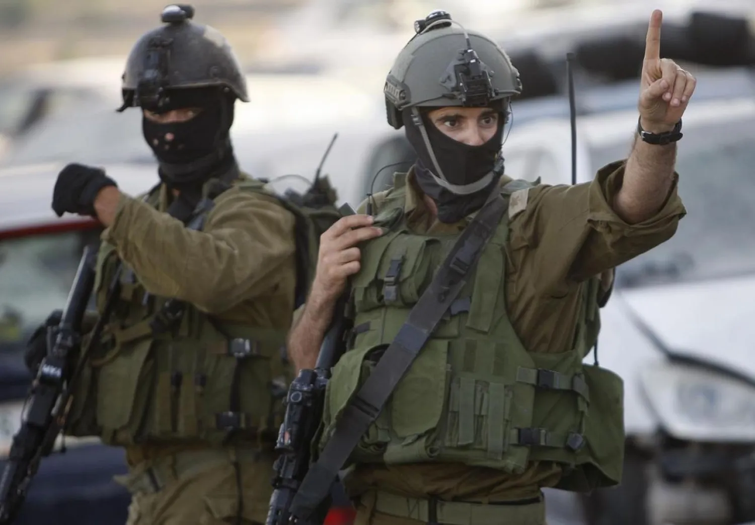 An Israeli soldier gestures as he takes part in an operation to locate three Israeli teens near the West Bank City of Hebron June 19, 2014. REUTERS/Mussa Qawasma