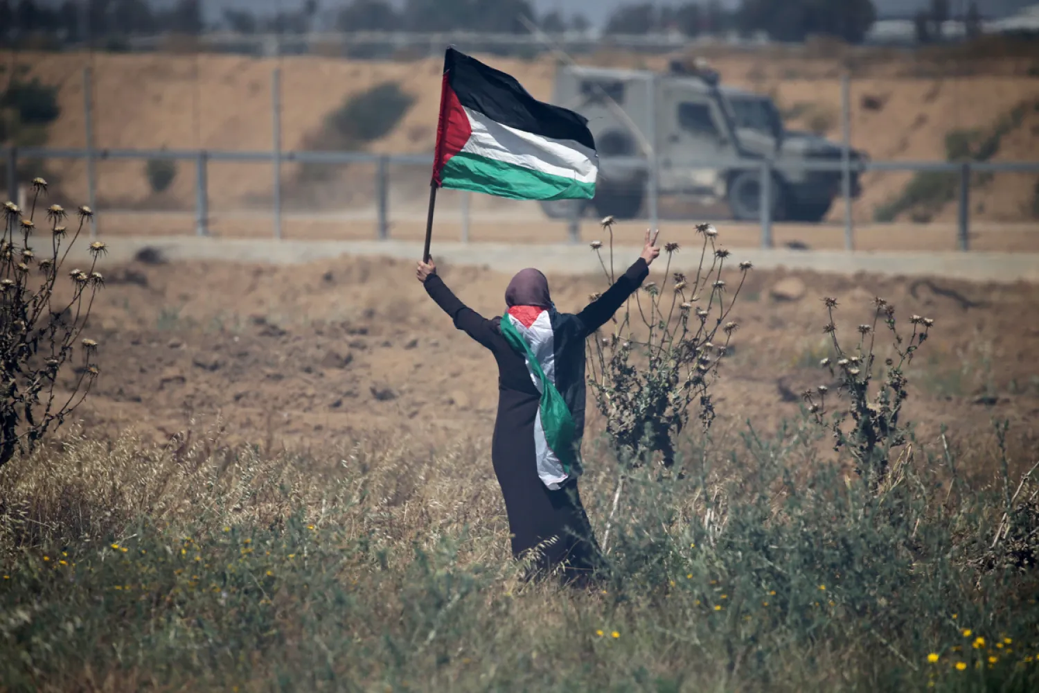 A Palestinian woman protesting at the separation fence in the southern Gaza Strip. IBRAHEEM ABU MUSTAFA/REUTERS