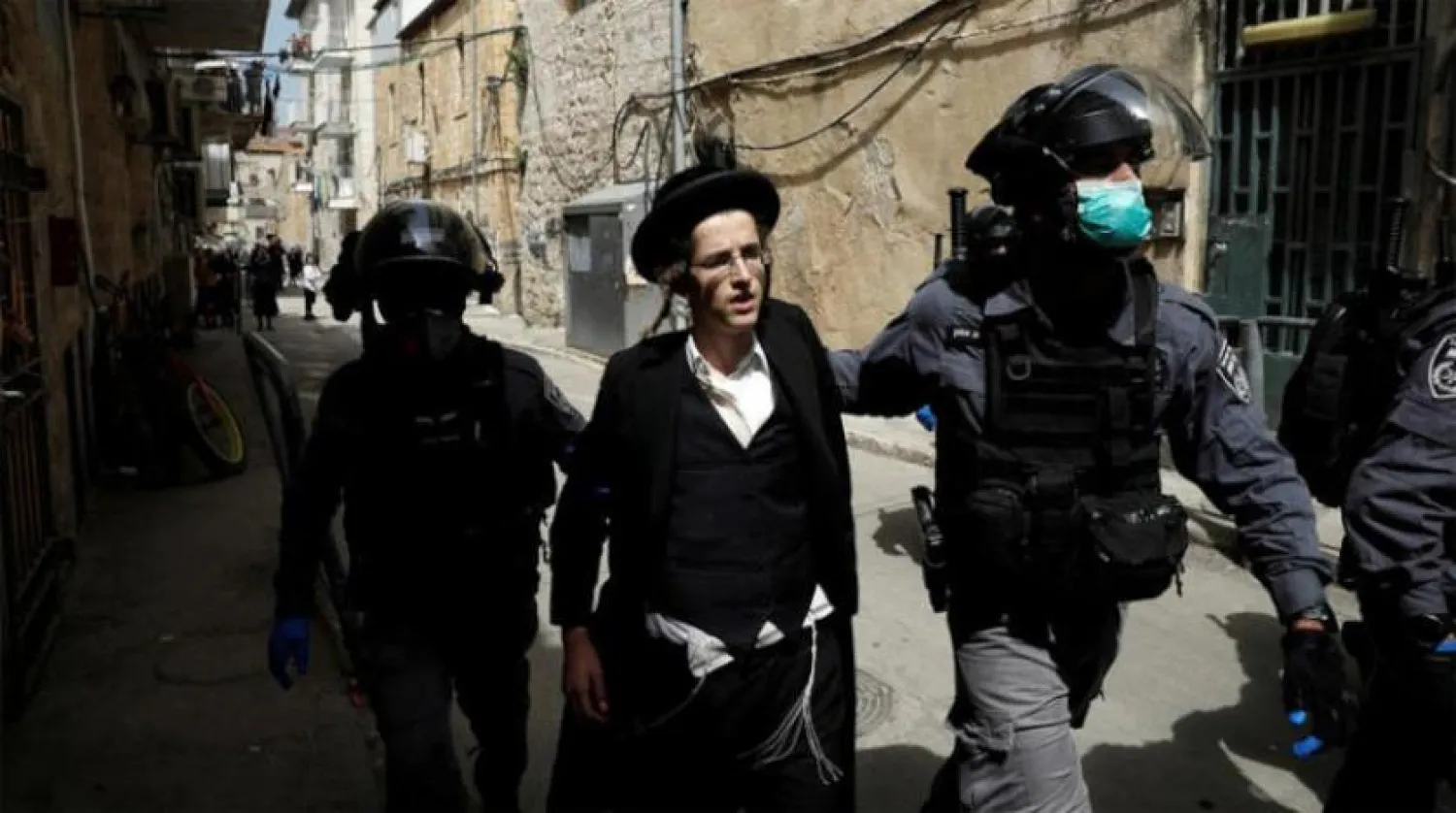 Israeli police arresting a person for violating health measures