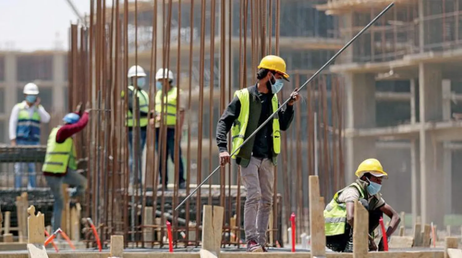 Workers and engineers at a construction site in Egypt’s new administrative capital (Reuters)