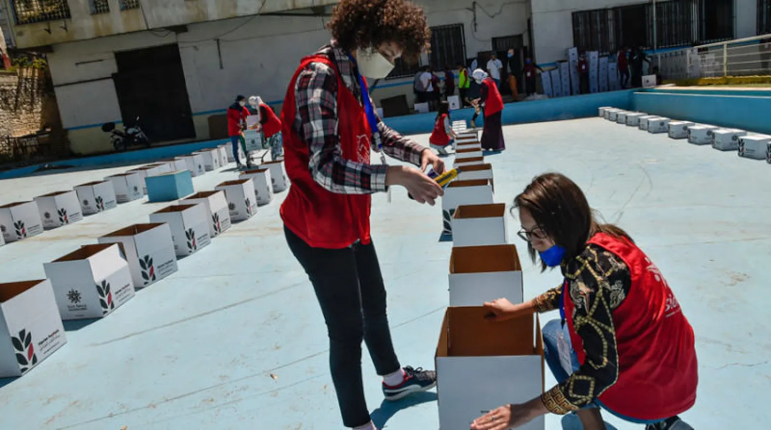 متطوعون يحضّرون وجبات غذائية في إطار حملة للتضامن الاجتماعي في العاصمة الجزائرية يوم الخميس (أ.ف.ب)